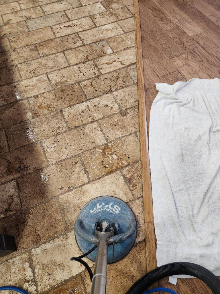 An image of natural stone tiles being professionally cleaned