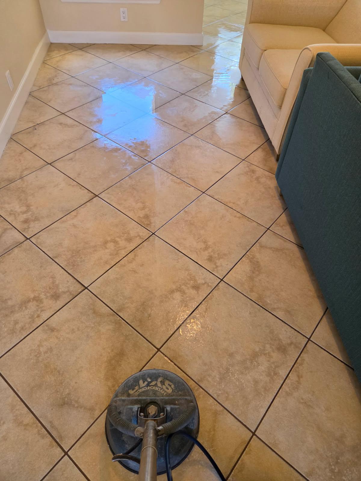 close-up of scrubber cleaning floor tile and grout