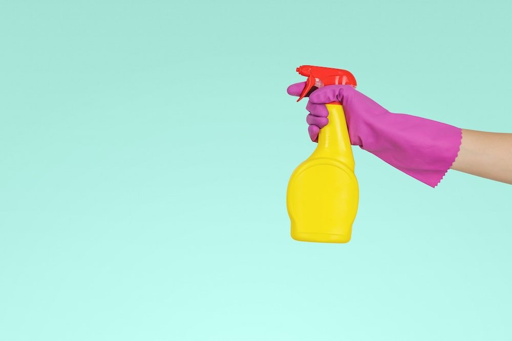 Person holding a spray bottle