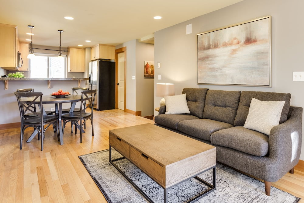 A coffee table on a rug on a wooden floor