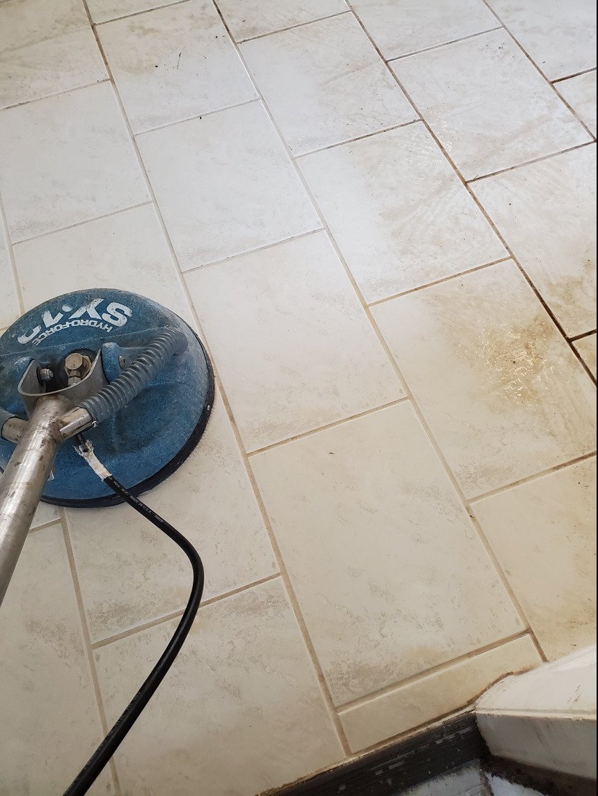 A steam cleaner on a tiled floor 