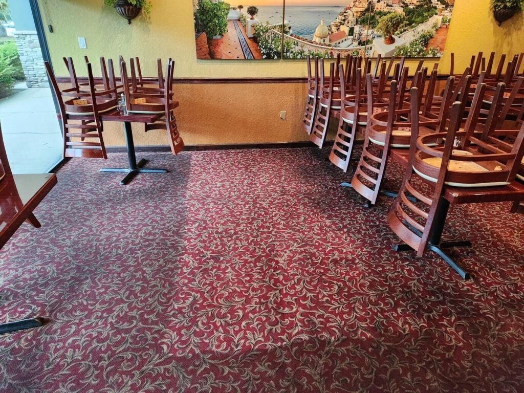 A restaurant after carpet cleaning with furniture upside down
