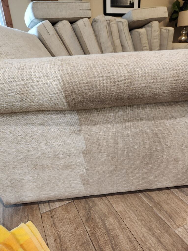 Cushions placed on the side during the sofa cleaning process