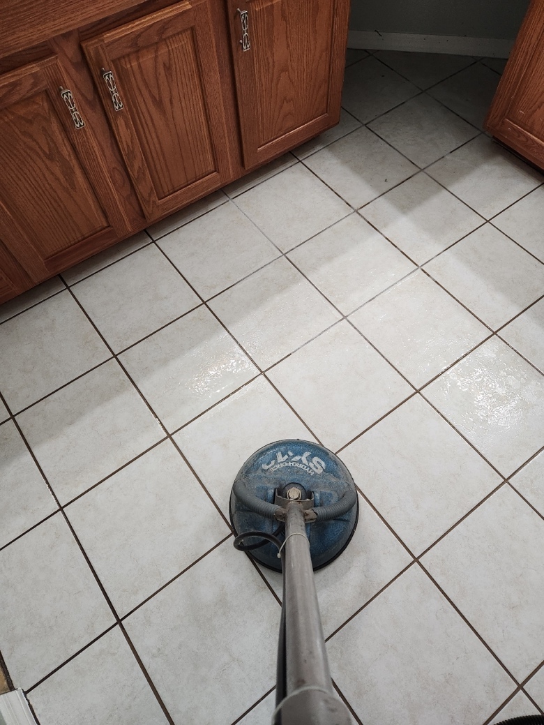  Professional grout cleaning on a white tile floor
