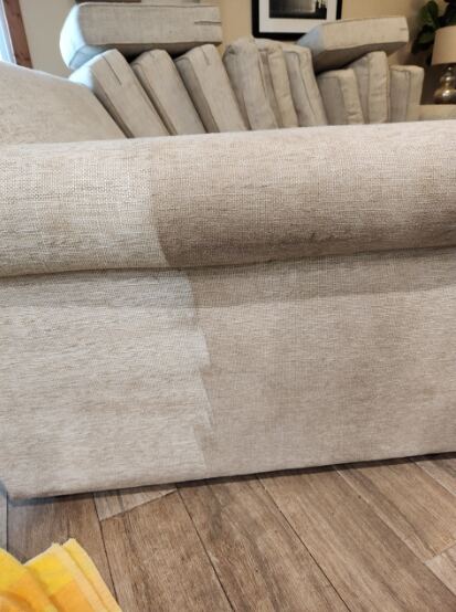 Cushions placed on the sofa during cleaning procedure