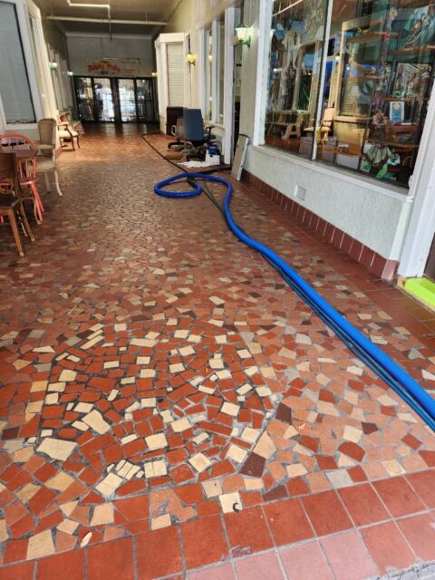 Professionals cleaning tiles on a property