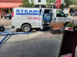 Steambrite Cleaning Services van parked outside a commercial building