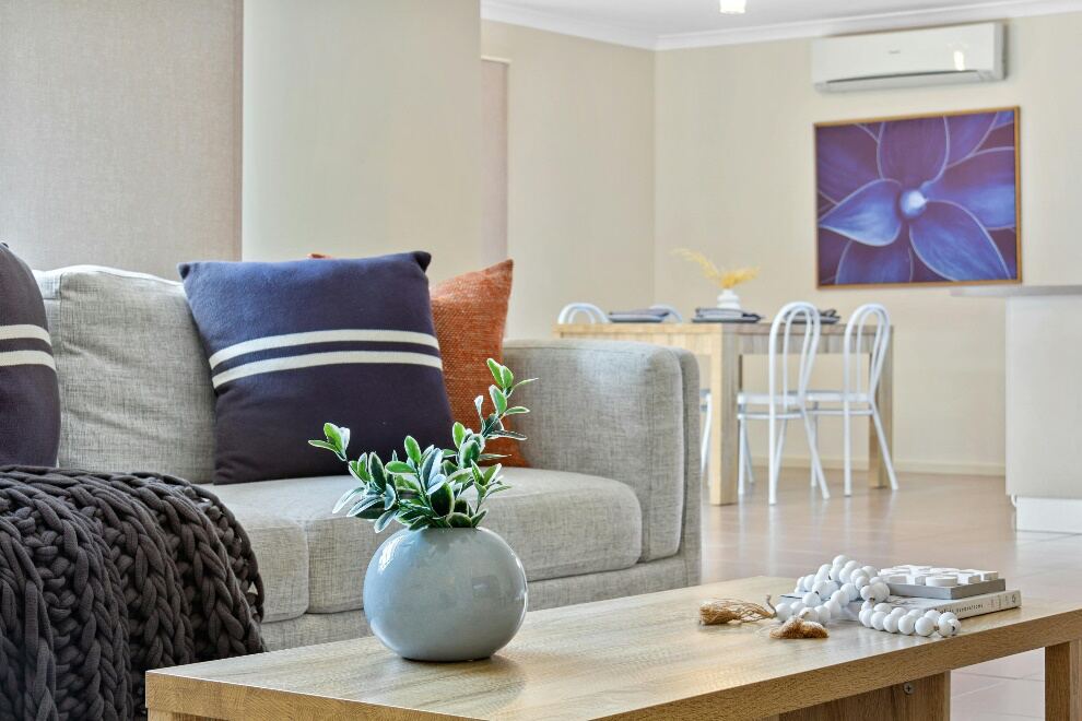 Different colored pillows set placed neatly in a stack on a sofa