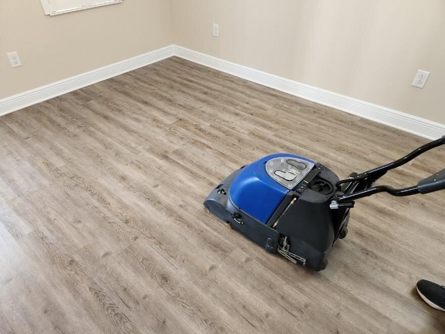 Person vacuuming a floor