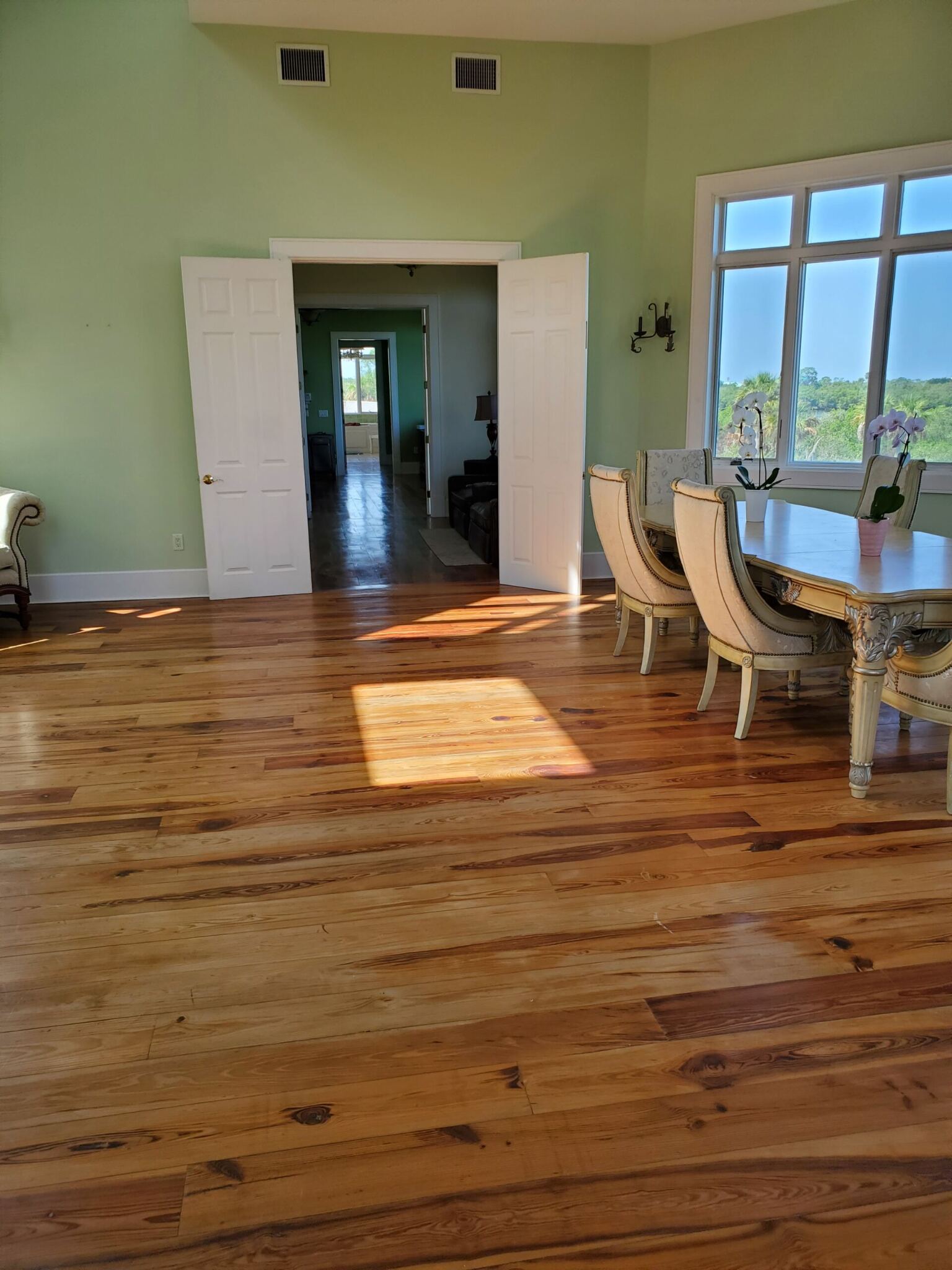 An image of a dining room with wood flooring