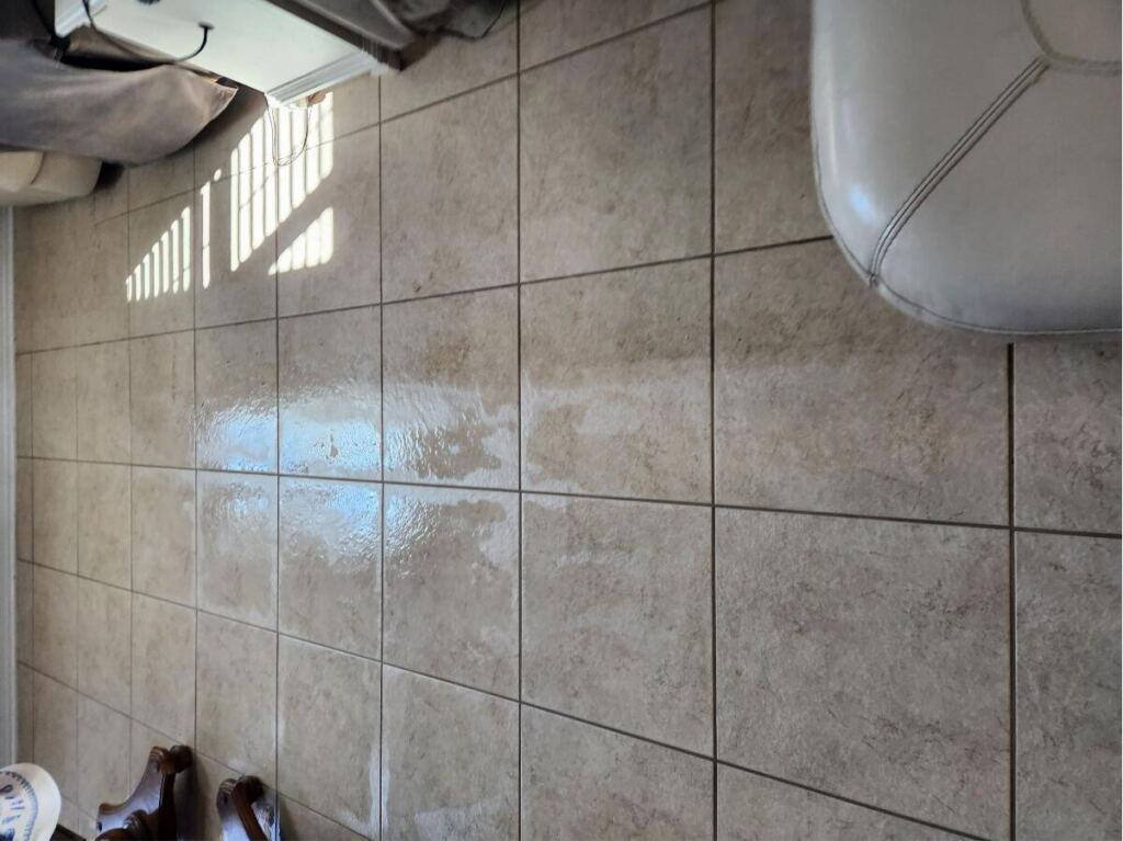 Shiny, freshly cleaned tile floor with sunlight reflecting off the surface.