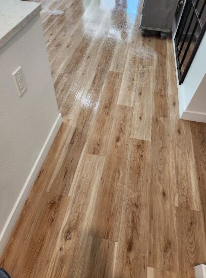 Professional hardwood floor cleaning in process.