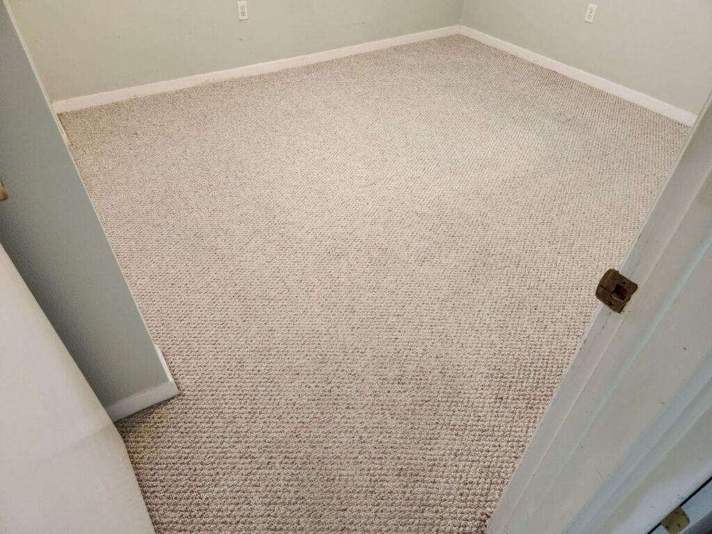 a clean white carpet laid out in an empty room
