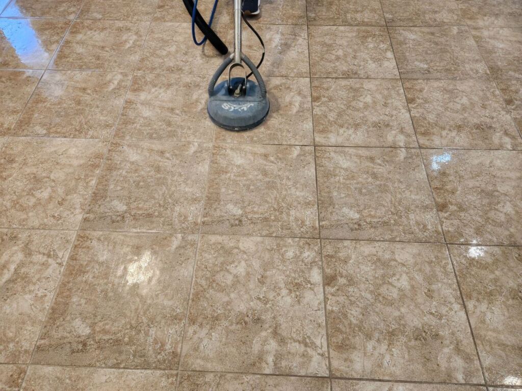 a cleaning service conducting grout cleaning on tiles