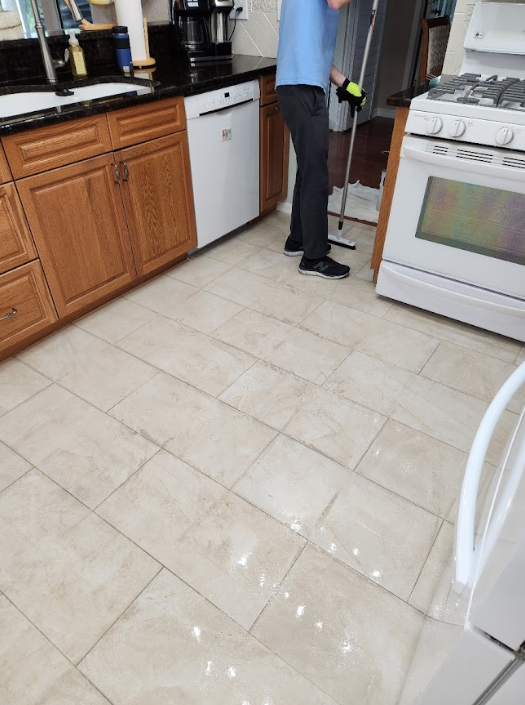 Clean kitchen tile floor with visible grout lines.