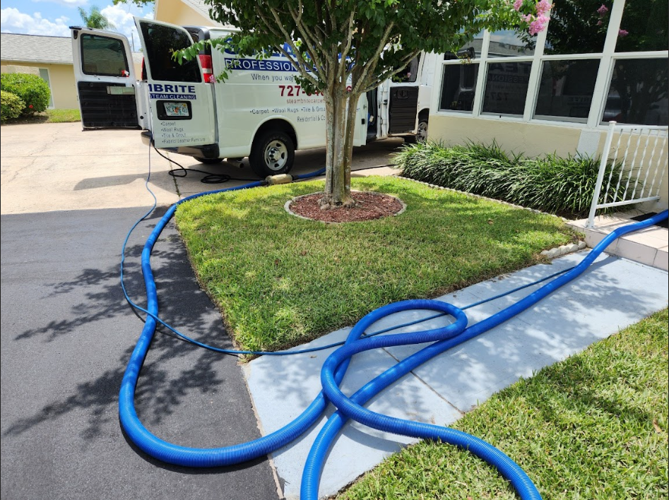Steambrite Cleaning Services truck parked in front of a house.
