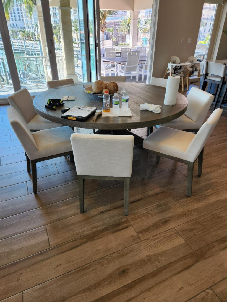 a dining table with cleaning supplies on it and freshly cleaned floors
