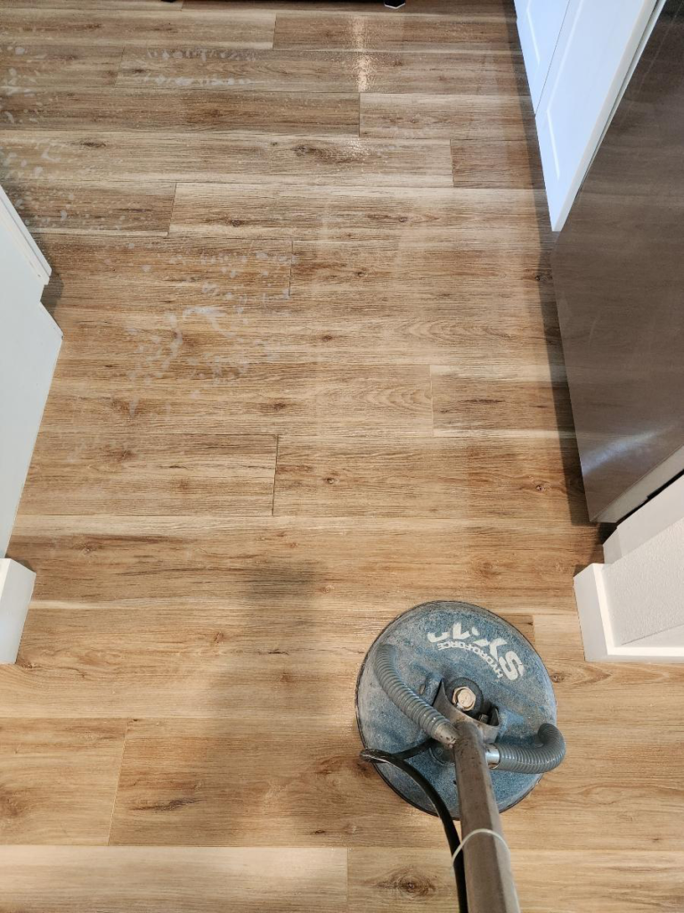 a wooden floor being cleaned using professional equipment