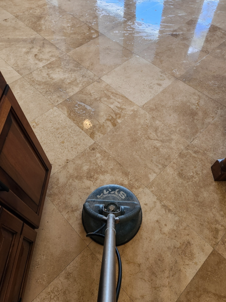 Professional surface cleaner restoring shine to beige tile flooring during deep cleaning service