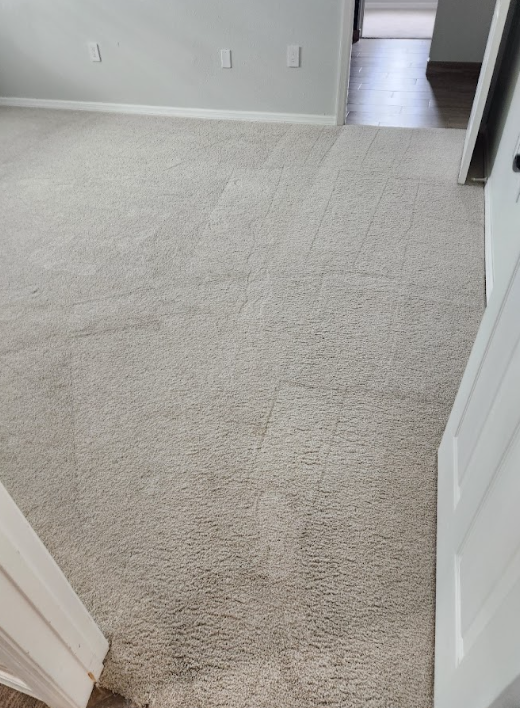 Light-colored carpet showing dirt buildup and stains before deep cleaning