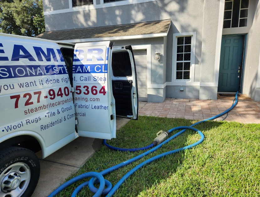 Carpet cleaning service truck with hoses set up for professional stain removal