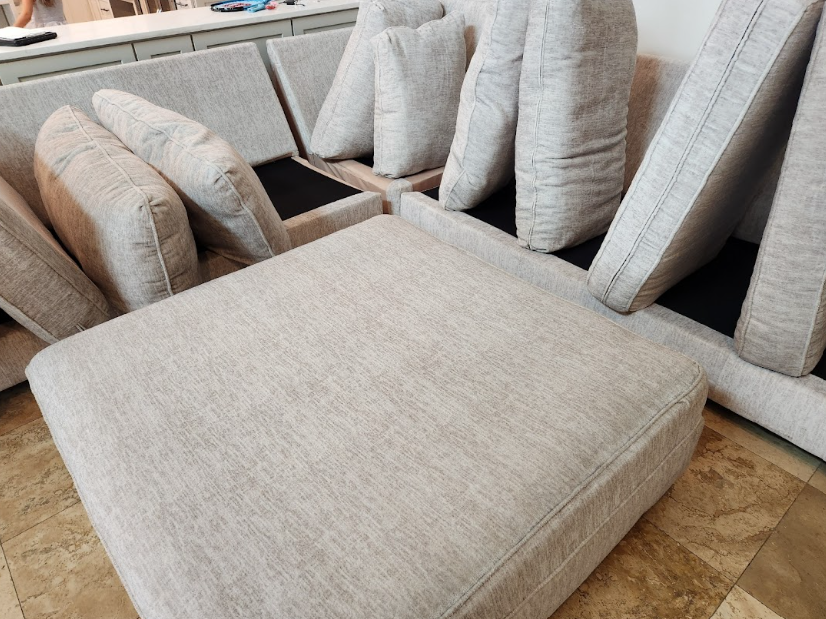 Sectional sofa cushions arranged for deep upholstery cleaning in the living room