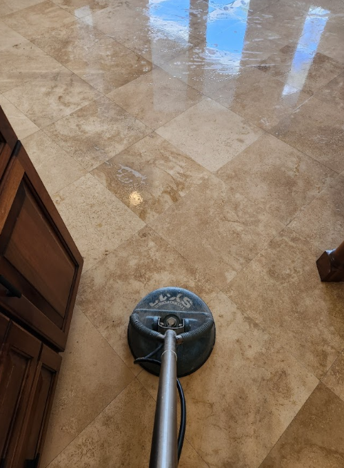 Tile floor being professionally cleaned with surface cleaner, removing buildup and residue