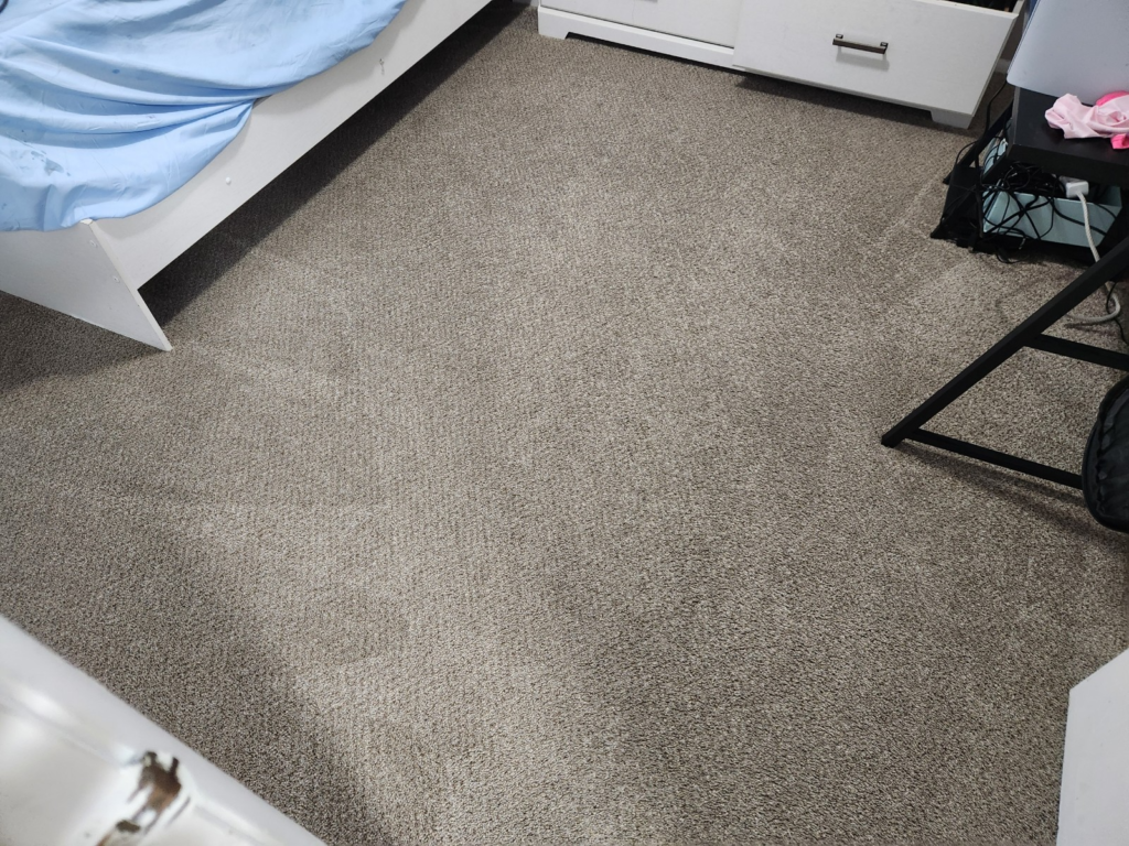 close-up of a grey carpeted flooring inside a bedroom