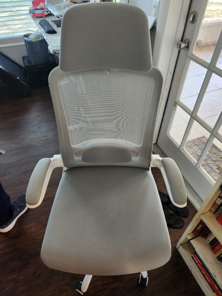 close-up of a grey chair with a cushion