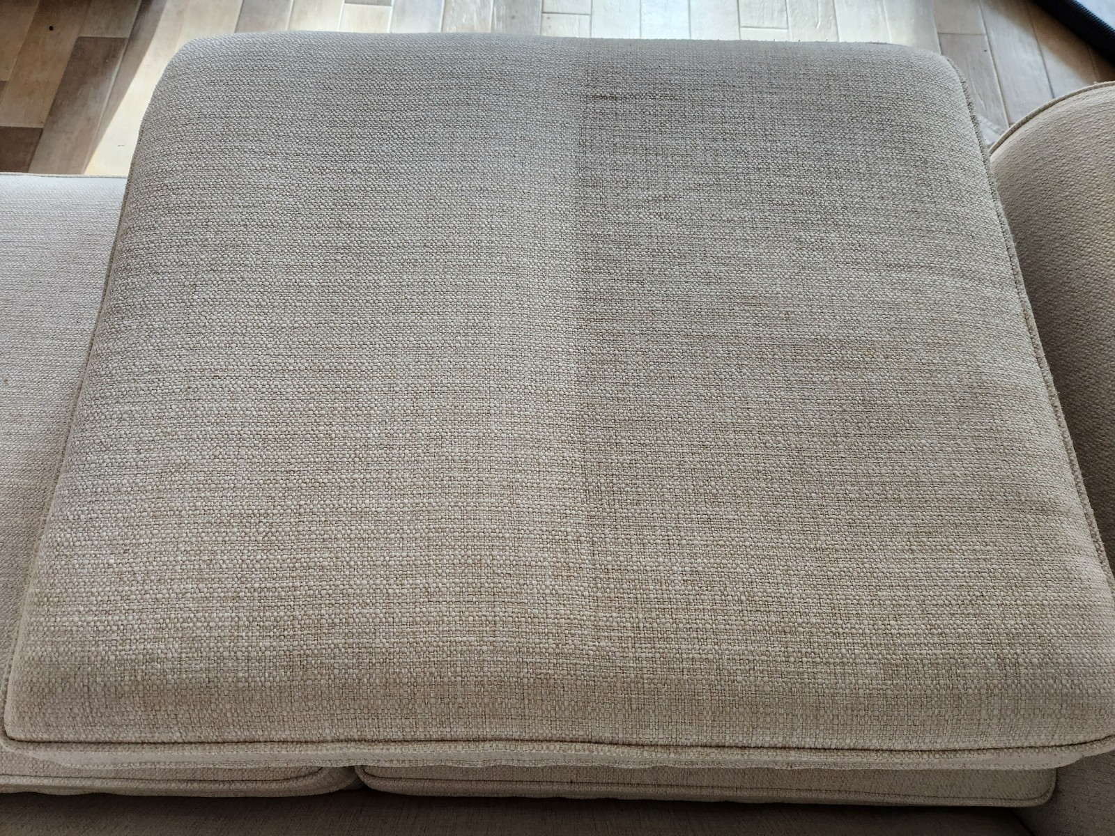 close-up of a grey sofa cushion with dirt buildup