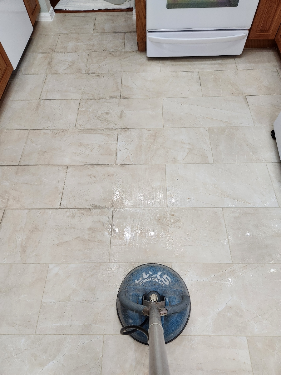 dirty grout lines being cleaned with the help of a rotary scrubber