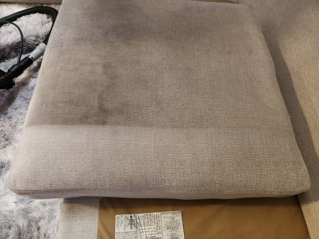 close-up of a dirty sofa cushion with stains