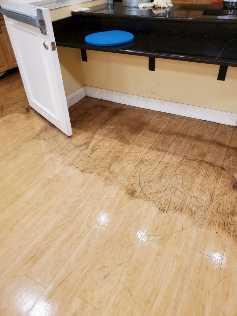 This photo shows a vinyl floor cleaning process taking place.