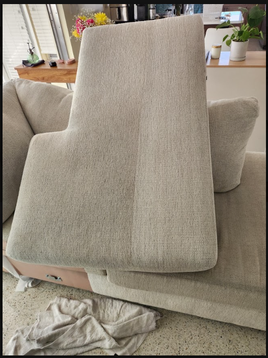 technician cleaning upholstered chair