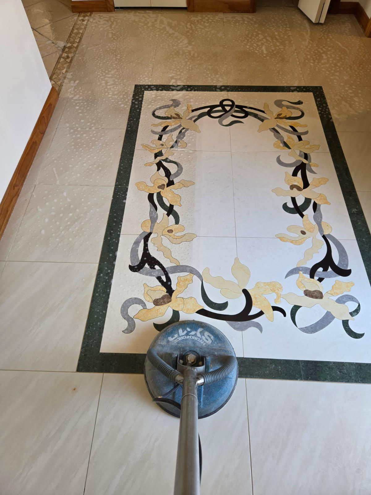An image of mosaic tiles being cleaned