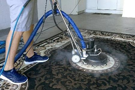 An image of an area rug being cleaned