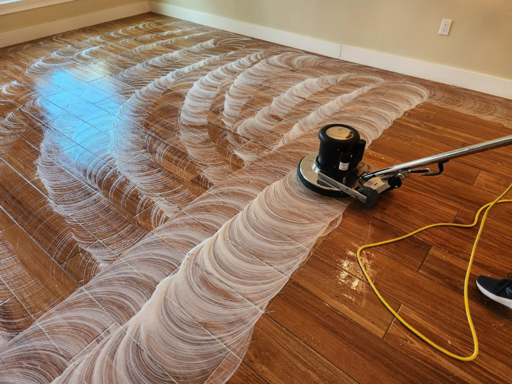 An image of vinyl flooring being power scrubbed by a professional