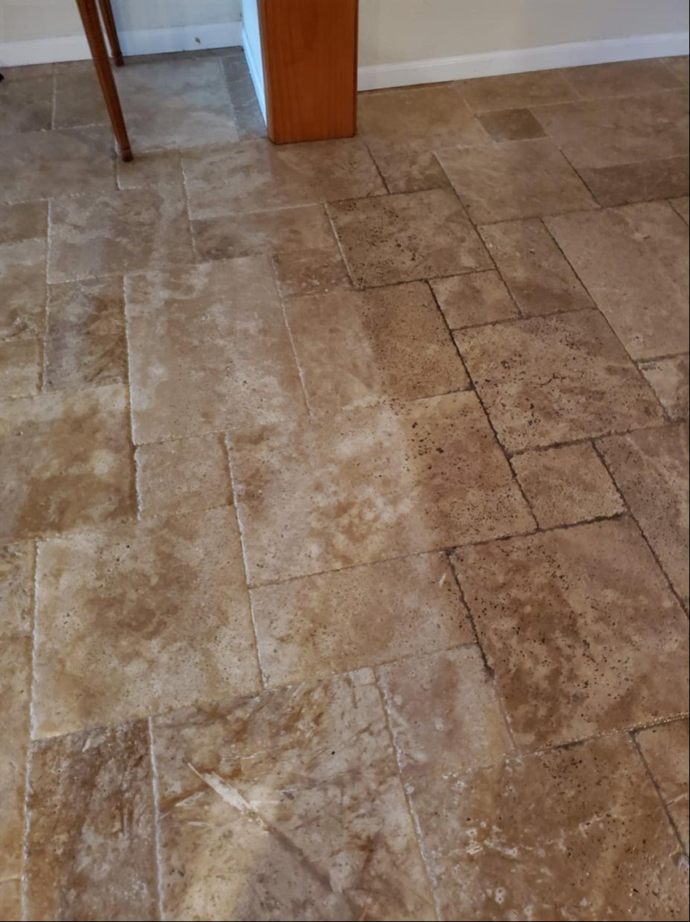 An image of stone tiles being cleaned showing before and after results