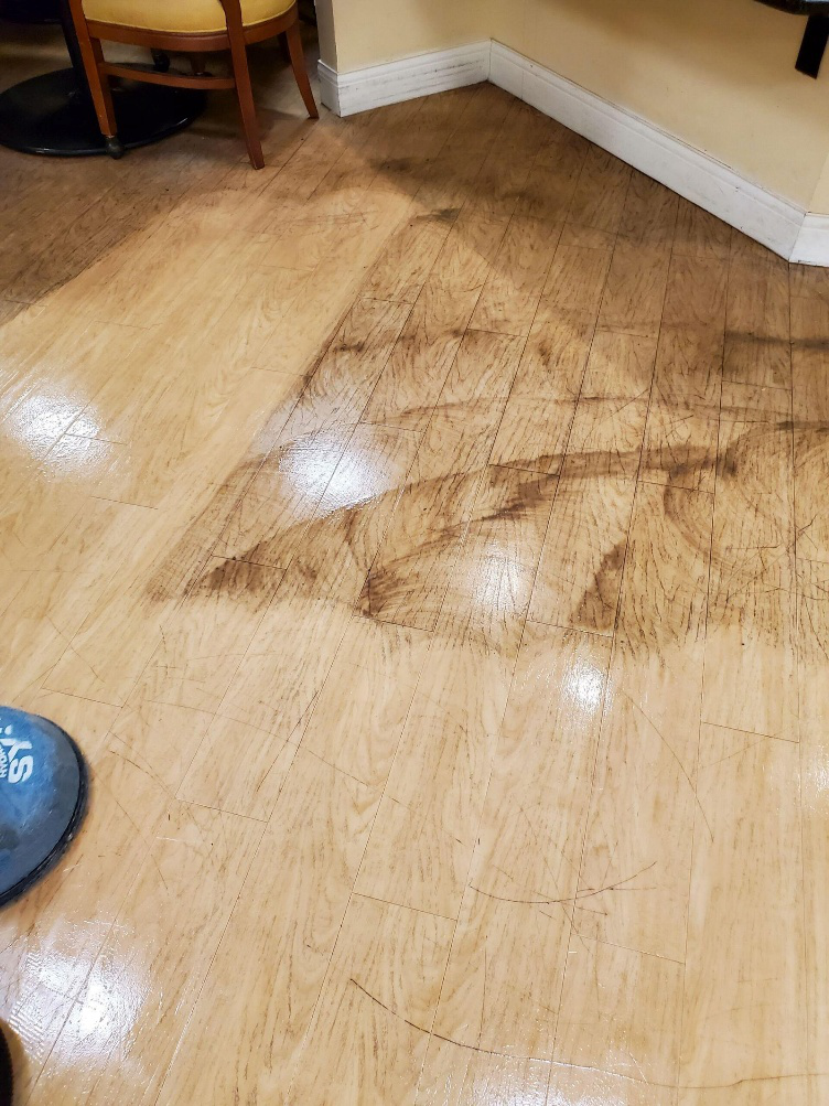 A ruined vinyl flooring in a room.