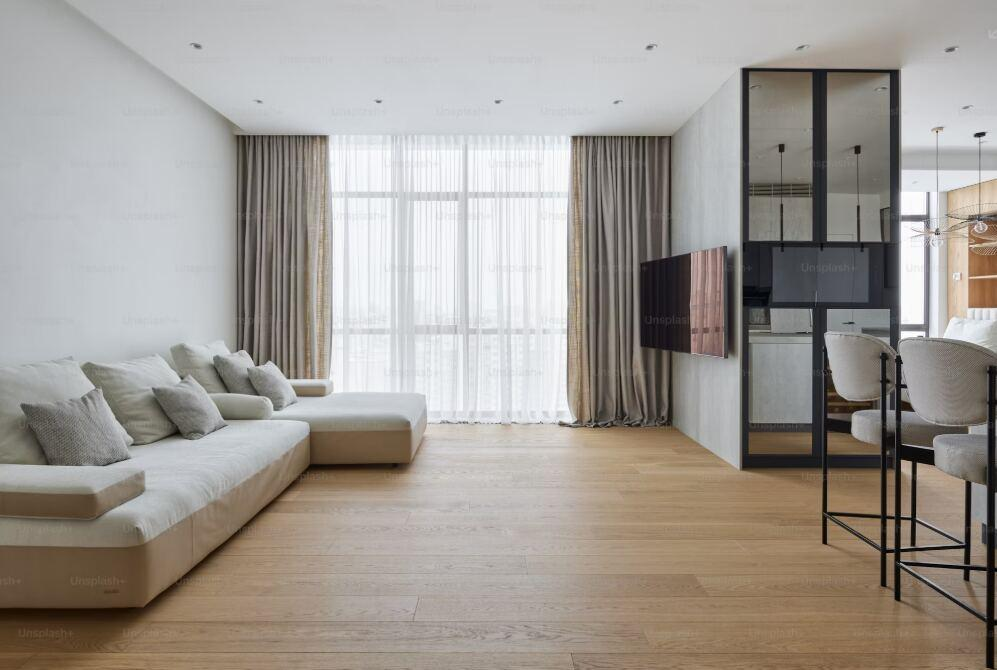 An image of a clean living room with wooden floor